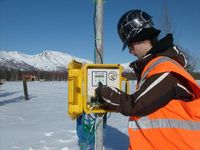 Inserting the Secure Digital (SD) card to record data from anemometer and wind vane.