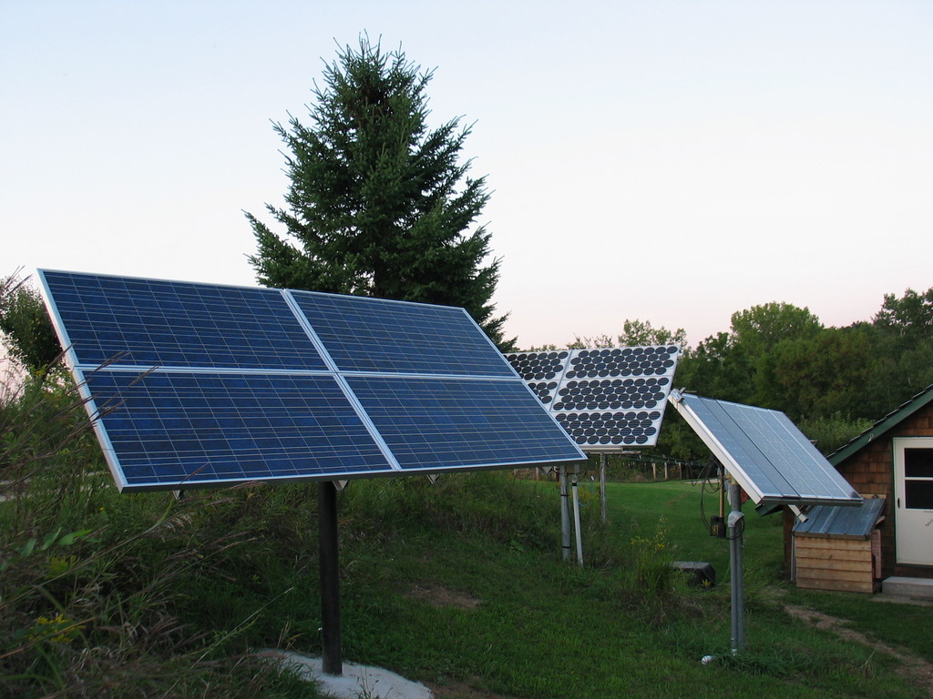 All three solar arrays. In the foreground is the new 660 watt array installed in the summer of 2006. The array to the right contains a variety of modules from the early 1980's to the mid 1990's. The 540 watt tracking array is in the background.