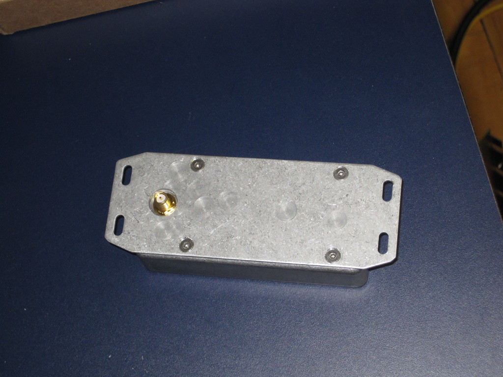 This side attached to the bottom of the PowerSyncII enclosure. Three holes are drilled. Two for mounting and one clearance hole for the RF connector.