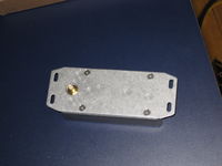 This side attached to the bottom of the PowerSyncII enclosure. Three holes are drilled. Two for mounting and one clearance hole for the RF connector.