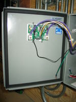 Data logger is mounted through the enclosure door. Current conditions are visible to verify system operation.