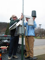 Clare Jarvis and Alyssa Anderson install the sensor mounting arm.