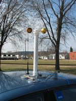 Three super strong magnets on an aluminum frame hold the anemometer in place. Standard 1.5" PVC is used. Stainless steel sheet metal screws hold the PVC together. The blue cord is a standard CAT5 patch cord that connects the anemometer to the Wind Monitor II.