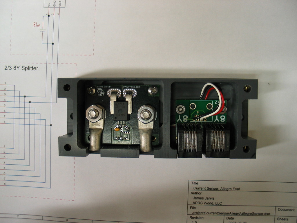 100 amp current sensor that is compatible with the Wind Data Logger. The current sensor is a hall effect sensor capable of -100 to 100 amps with a 150 amp survival rating. Because the sensor is hall effect, there is very little voltage drop across it. It is also isolated to 3kV. 1/4-20" bolts are used to attach to standard lugs. The sensor body is CNC machined from a block of PVC plastic. A clear plastic cover is included, but not shown.