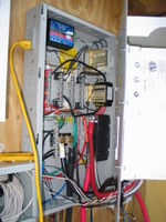 Inside of the Midnite Solar E-Panel. It's getting more crowded. In the upper left is the Watt Node. It measures the power and energy output from the inverter.