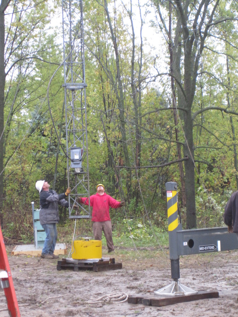 Guiding the tower onto the base pin.