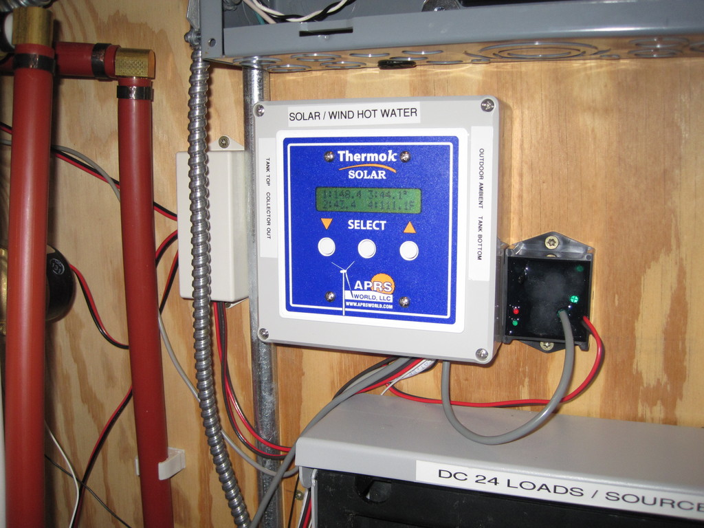 An APRS World ThermokSolar-4A runs the show.

It controls:

Two Liang EcoCirc circulation pumps for the solar hot water heating loop.
One Liang EcoCirc pump for domestic heating.
Morningstar Tri-Star dump controller. Prevents the Tri-Star from boiling the hot water tank.


It monitors:

Tank top temperature
Collector out temperature
Outdoor ambient temperature
Tank bottom temperature
Water meter (gallons)
Input voltage
Battery voltage
