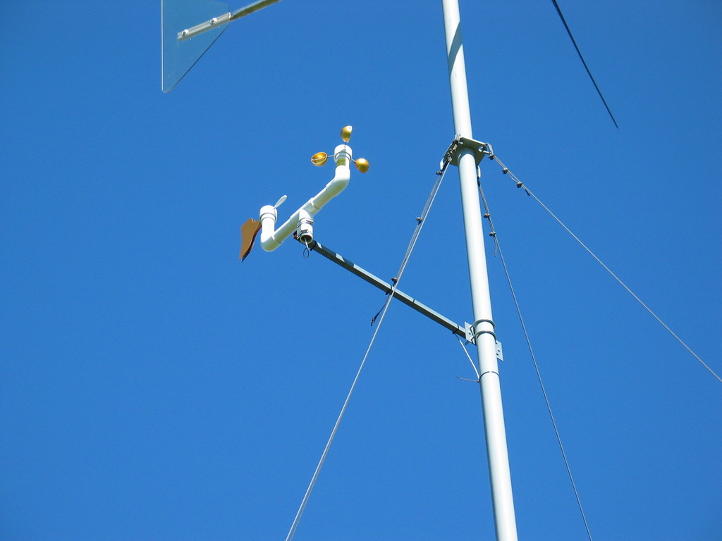 Mounting arm with anemometer, wind vane, and tee installed.