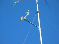 Mounting arm with anemometer, wind vane, and tee installed.