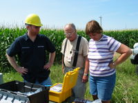 James Jarvis shows the equipment to the parents of the customer.