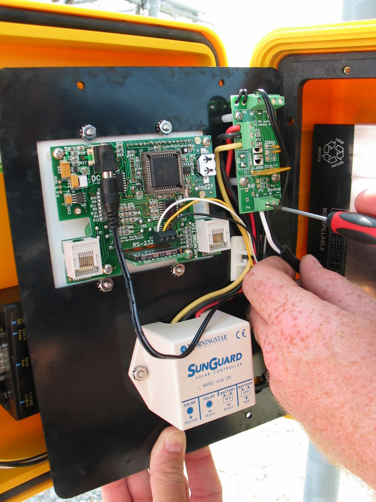The solar panel is connected to the power board inside the enclosure. The white wire is positive (+) and the black wire is negative / ground (-).