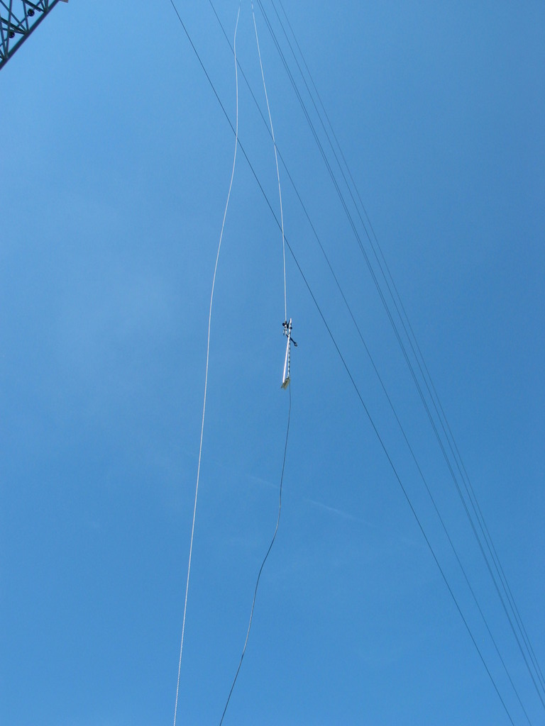The sensor boom is pulled up the tower with a rope. The sensors, booms, and wiring is assembled on the ground and pulled into location ready to go. This saves signficant time and effort up the tower.