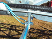 Detail of mounting rigid conduit to Bergey Excel SSV tower for an anemometer boom.