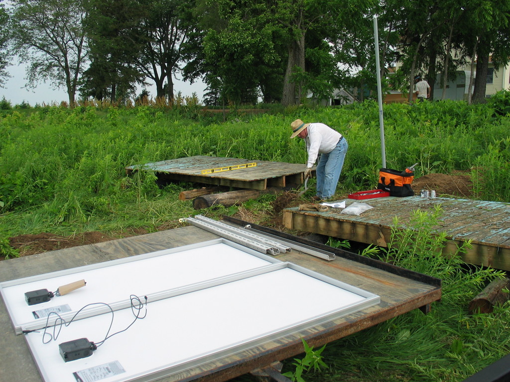 Jim Heaser works on leveling the old decks that will serve as the base for the solar panels.