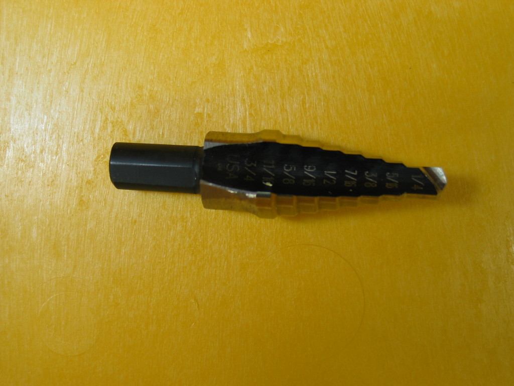 Modified Uni-bit for drilling 11/16 holes for 3/8 NPT weatherproof feedthrus. It produces excellent burr-free holes in the polypropelyne Pelican cases.