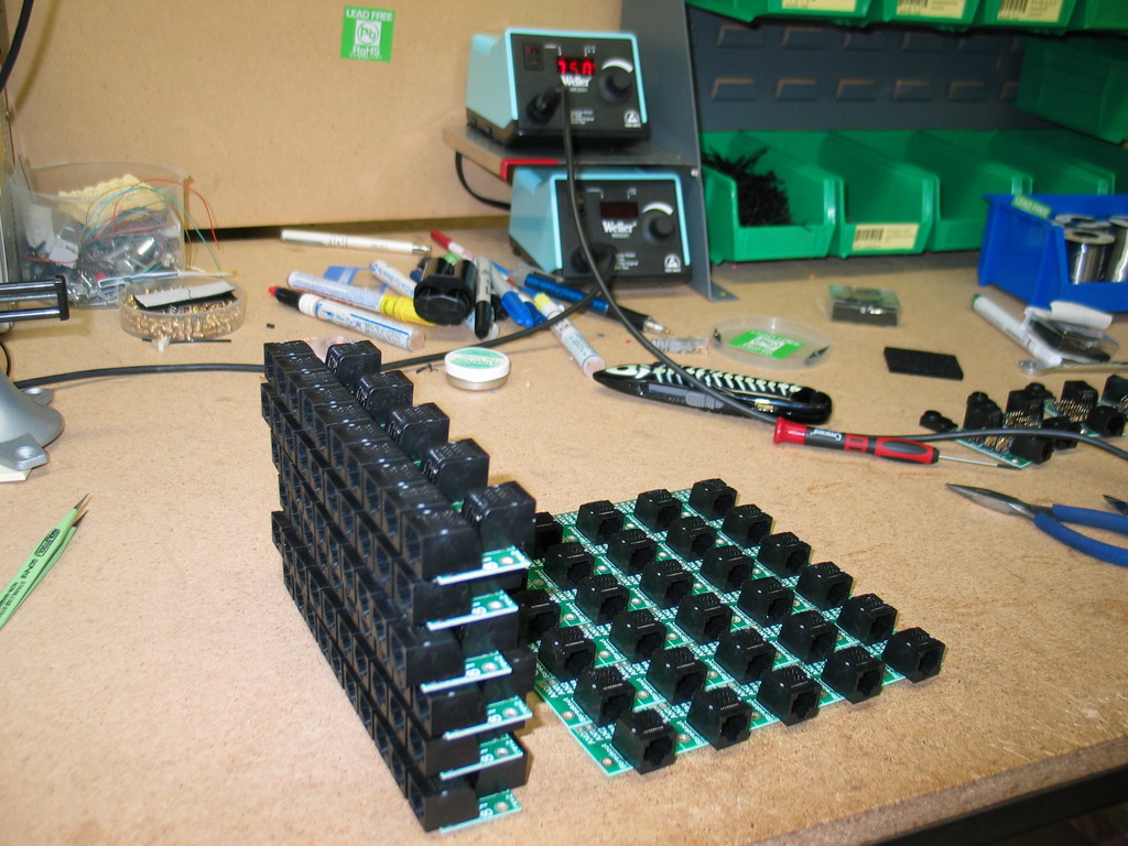 Many 8Y and RJ-45 breakout boards being assembled. TempRhLight's in the background. And a dirty workbench.