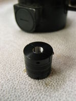 A helical beam coupler is used to attach the encoder shaft to the motor shaft. It replaces a 3/8"-24 nut that holds the worm on to the motor shaft. I bored and tapped one side of the coupler to take the place of the original nut. 