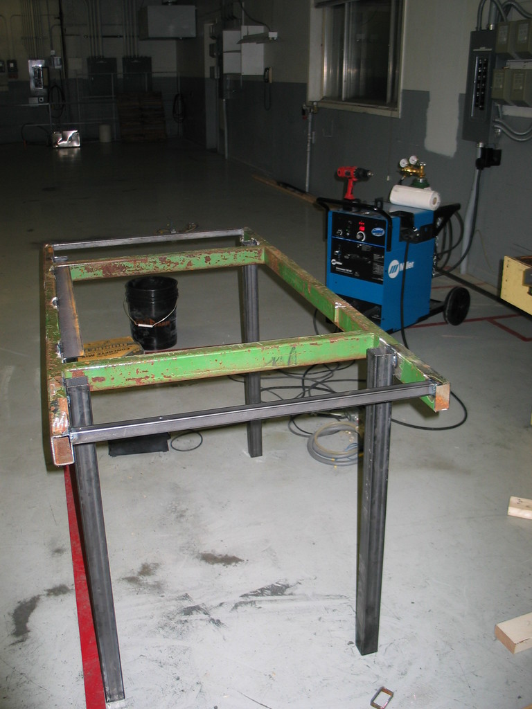 Workbench under construction. The green steel came from a discarded John Deere fixture. There was about 300 pounds more of John Deere fixture that had to be cut away first.