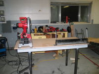 Currently there is a bench grinder, drill press, and vise also on the table. Eventually an outfeed and stop for the dry cut saw will be fabricated. Note the high quality rattle can primer. I got bored and sick of primering before getting to the legs. Fortunately they still have tons of metal protectant left of them...