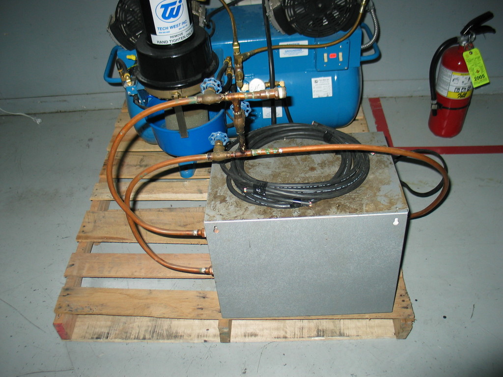The gray box in the foreground is an air chiller. It should get rid of any moisture in the air.