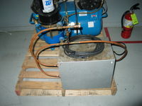 The gray box in the foreground is an air chiller. It should get rid of any moisture in the air.