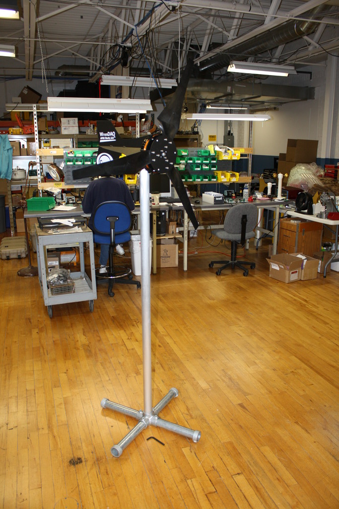 Display stand for small wind turbines. Accommodates any turbine that uses 1.5" schedule 40 pipe. This includes the Chinook 200, and Southwest Wind Power's Air line of turbines.