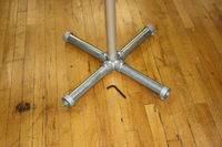Vertical member is 1.5" schedule 40 aluminum pipe. Brushed finish. The base is galvanized scheduled 40 steel pipe for weight and stability. Assembly is accomplished in about 30 seconds using the supplied Allen wrench.