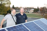 Darryl Thayer and James Jarvis installing a grid tie PV system on a school.