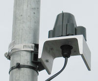 Close up view of Solar Radiation Sensor and APRS World's side of pole mounting bracket.