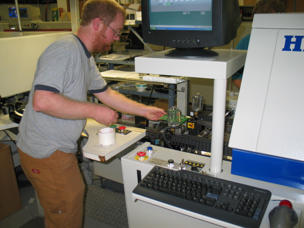 The placed board goes into the reflow oven. The oven has multiple zones the ramp the temperature up and until the solder melts. The board is then quickly cooled down before it slides out the other end of the conveyor.