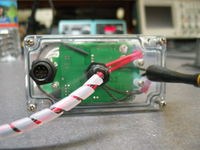 Bottom cover of the WrenDAQ2. The weatherproof connector on the left is for connecting the external temperature sensor, anemometer, and RPM sensor. The middle feedthru is for DC, AC (to pickup frequency), and ground. The antenna on the left is for the 900 MHz ISM modem.