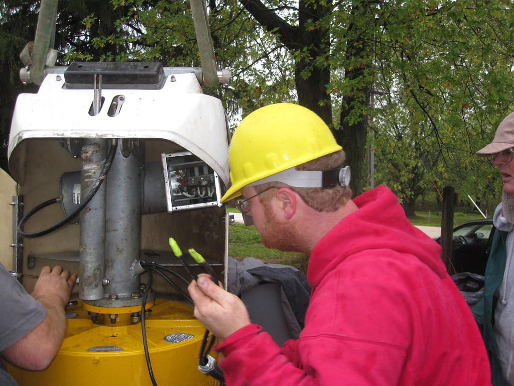 Runnning alternator output wires through flex conduit and into the slip rings. Eric Pipkin bolting the alternator on.
