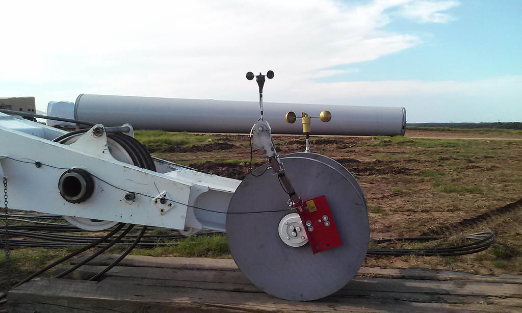 APRS World's #40HC anemometer (APRS6506) in foreground uses a pivoting head mount (APRS7602) vs. unreliable factory supplied anemometer to right
