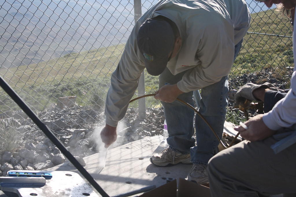 Using compressed nitrogen to blow the concrete dust out of the holes