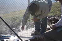 Using compressed nitrogen to blow the concrete dust out of the holes